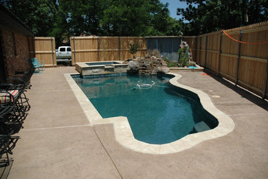 Inspiration for a small timeless backyard stamped concrete and custom-shaped natural hot tub remodel in Other