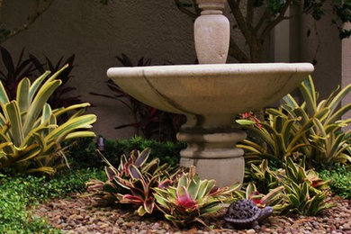 Inspiration for a tropical partial sun side yard stone garden path in Miami.
