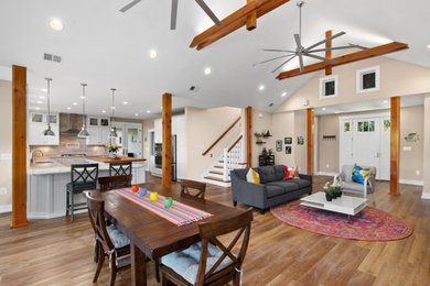 Inspiration for a light wood floor, brown floor and exposed beam dining room remodel in Baltimore with beige walls, a corner fireplace and a brick fireplace