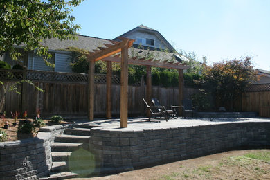 Inspiration for a mid-sized traditional full sun backyard landscaping in Vancouver.