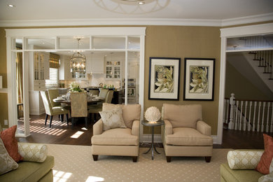 Example of a mid-sized classic enclosed dark wood floor living room library design in Toronto with a standard fireplace, a wood fireplace surround, a media wall and brown walls