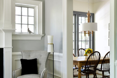 Example of a mid-sized classic formal and enclosed medium tone wood floor and brown floor living room design in New York with gray walls, a standard fireplace and no tv