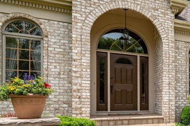 Inspiration for a large timeless multicolored two-story mixed siding exterior home remodel in Chicago with a shingle roof