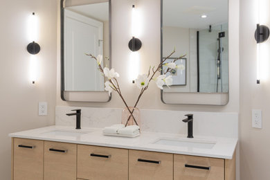Trendy double-sink bathroom photo in Montreal with flat-panel cabinets, quartz countertops, white countertops and a built-in vanity