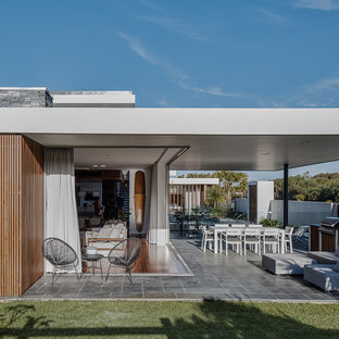 Inspiration for a small contemporary patio in Gold Coast - Tweed with tile and a roof extension.