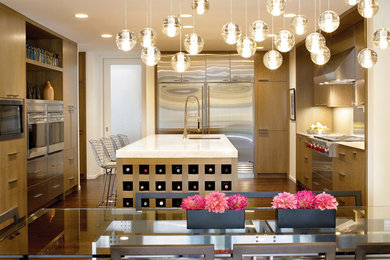 Example of a large trendy u-shaped dark wood floor and brown floor eat-in kitchen design in San Francisco with a single-bowl sink, flat-panel cabinets, medium tone wood cabinets, quartzite countertops, stainless steel appliances, an island, metal backsplash, metallic backsplash and green countertops