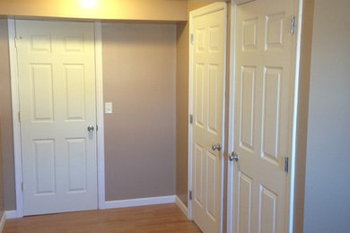 Inspiration for a transitional laminate floor mudroom remodel in Other with beige walls