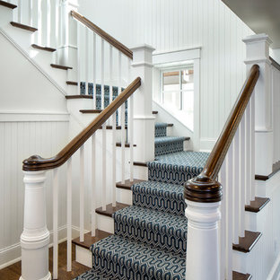 Example of a classic wooden u-shaped staircase design in Minneapolis with painted risers