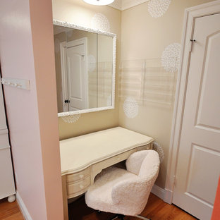 This is an example of a large eclectic bedroom in DC Metro with pink walls, medium hardwood floors and no fireplace.