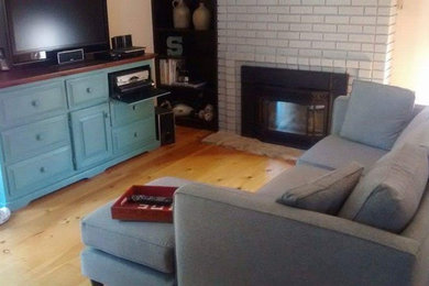 Living room - mid-sized transitional open concept light wood floor living room idea in Toronto with beige walls, a standard fireplace, a brick fireplace and a tv stand