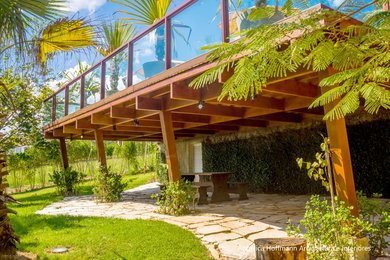 Inspiration for a large coastal house exterior remodel in Other with a tile roof