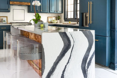 Inspiration for an eclectic l-shaped eat-in kitchen in DC Metro with blue cabinets, quartz benchtops, white splashback, with island and white benchtop.