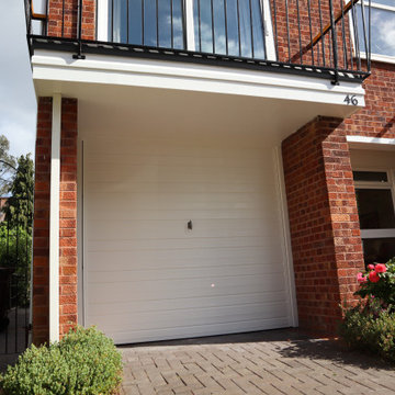 Front exterior - garage door, hand rail, and railing in West Wimbledon