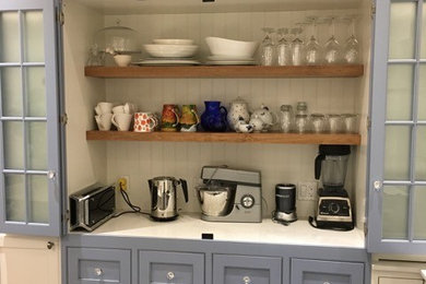 Eat-in kitchen - small transitional u-shaped dark wood floor and brown floor eat-in kitchen idea in Toronto with recessed-panel cabinets, white cabinets, a farmhouse sink, marble countertops, white backsplash, brick backsplash, stainless steel appliances and a peninsula