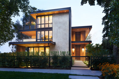 Example of a minimalist beige two-story stone exterior home design in Denver