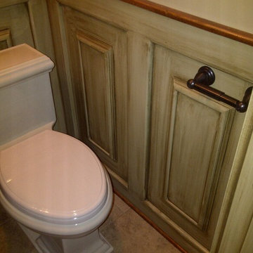 glazed wainscoting with 1 piece toilet and brick pattern floor