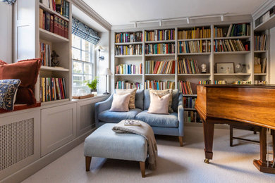 This is an example of a small traditional enclosed games room in London with a music area, a reading nook, grey walls, carpet, no fireplace, a built-in media unit, feature lighting and grey floors.