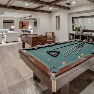 Design ideas for a mediterranean basement in Los Angeles with white walls and medium hardwood flooring.