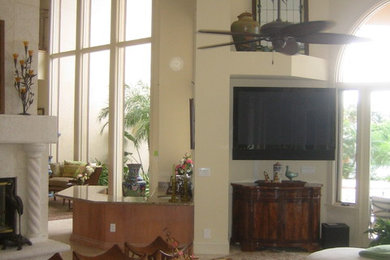 Example of a large island style open concept ceramic tile living room design in New York with white walls, a two-sided fireplace, a stone fireplace and a wall-mounted tv