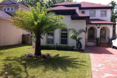 Inspiration for a full sun front yard brick landscaping in Tampa for summer.