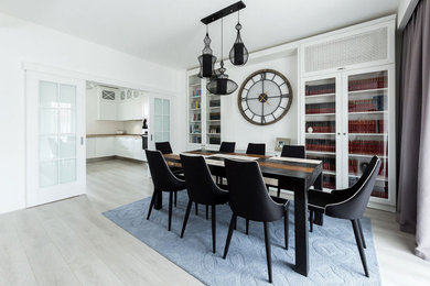 Example of a mid-sized eclectic laminate floor and gray floor dining room design in Other with white walls