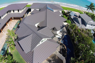 Example of a beach style home design design in Other