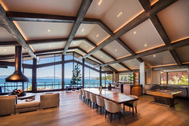 Inspiration for a large contemporary medium tone wood floor and brown floor great room remodel in Other with beige walls and no fireplace