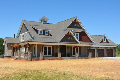 Large arts and crafts beige two-story mixed siding exterior home photo in Other