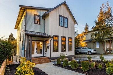 Mid-sized farmhouse exterior home idea in Seattle
