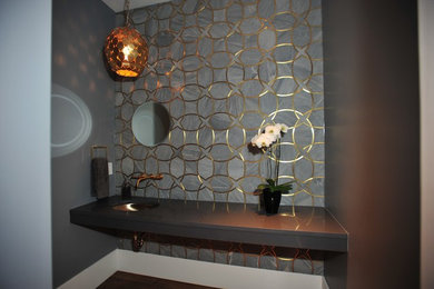 Photo of a large contemporary powder room in Calgary with an undermount sink, engineered quartz benchtops, gray tile and grey walls.