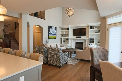 Example of a mid-sized transitional open concept light wood floor family room design in Calgary with gray walls, a tile fireplace and a wall-mounted tv