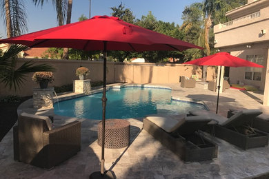 Island style pool photo in Phoenix