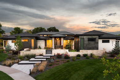 Large trendy house exterior photo in Denver with a mixed material roof and a black roof