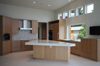Open concept kitchen - contemporary porcelain tile open concept kitchen idea in Vancouver with light wood cabinets, flat-panel cabinets, a drop-in sink, quartz countertops, multicolored backsplash, paneled appliances and an island