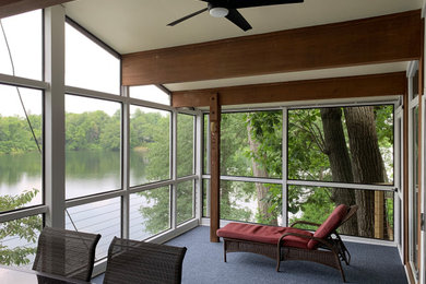 Large 1960s screened-in and cable railing back porch idea in St Louis with a roof extension