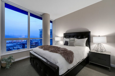 This is an example of a mid-sized contemporary master bedroom in Vancouver with grey walls and carpet.