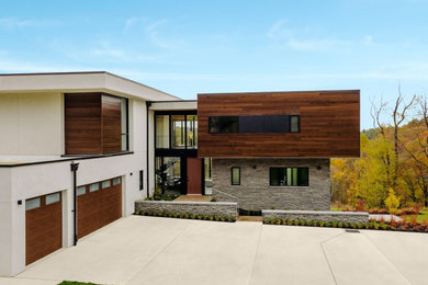 Example of a large minimalist attached three-car garage design in Cincinnati