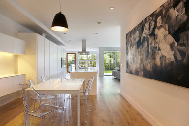 Mid-sized contemporary open plan dining in Los Angeles with light hardwood floors.