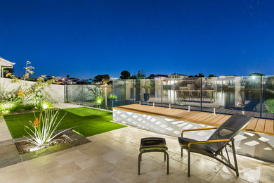 Photo of a small contemporary backyard full sun formal garden in Adelaide with natural stone pavers.