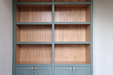Photo of a small traditional home office in London with white walls and light hardwood flooring.