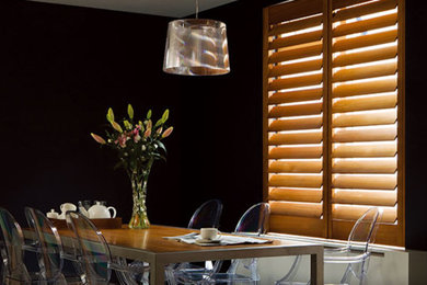 Inspiration for a mid-sized transitional enclosed dining room remodel in Los Angeles with black walls