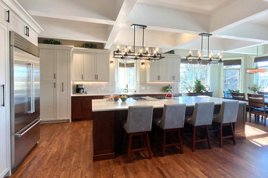 Example of a large transitional single-wall dark wood floor, brown floor and coffered ceiling eat-in kitchen design in Calgary with an undermount sink, shaker cabinets, gray cabinets, quartzite countertops, multicolored backsplash, stone slab backsplash, stainless steel appliances, an island and multicolored countertops