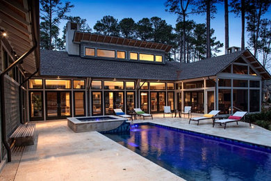 Example of a trendy backyard stone and rectangular lap hot tub design in Charleston