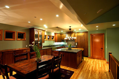 Eat-in kitchen - contemporary l-shaped eat-in kitchen idea in San Francisco with a farmhouse sink, shaker cabinets, dark wood cabinets, quartz countertops and paneled appliances