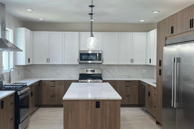 Large 1950s u-shaped porcelain tile and beige floor kitchen photo in New York with an undermount sink, flat-panel cabinets, dark wood cabinets, quartzite countertops, white backsplash, quartz backsplash, stainless steel appliances, an island and white countertops