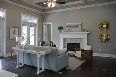 Example of a large trendy formal and open concept dark wood floor and brown floor living room design in Tampa with gray walls, a standard fireplace, a tile fireplace and no tv