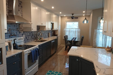 Mid-sized transitional galley porcelain tile and multicolored floor eat-in kitchen photo in Baltimore with an undermount sink, recessed-panel cabinets, white cabinets, quartz countertops, blue backsplash, ceramic backsplash, no island, white countertops and stainless steel appliances
