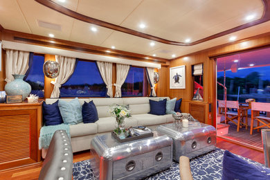 Inspiration for a mid-sized coastal formal and enclosed dark wood floor and brown floor living room remodel in Miami with brown walls and no fireplace