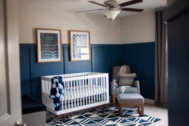Inspiration for a mid-sized boy carpeted, beige floor and wainscoting nursery remodel with blue walls