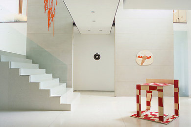 This is an example of a contemporary hallway in DC Metro with white walls and white floor.